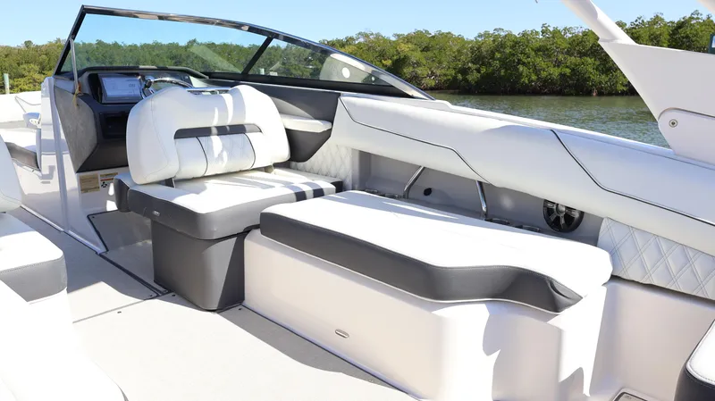Slide: The Image of 2022 Regal LX4 boat interior with sleek white seating and modern dashboard design. - 31