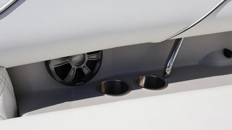 Slide: The Image of 2022 Regal LX4 boat interior with speaker and cup holders. - 33