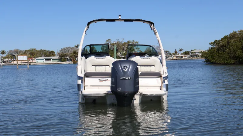 Slide: The Image of 2022 Regal LX4 boat on calm water, rear view with outboard motor. - 4