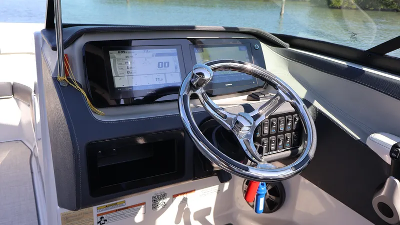 Slide: The Image of 2022 Regal LX4 boat dashboard with steering wheel and digital display. - 40