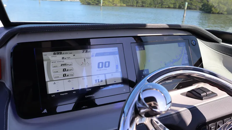 Slide: The Image of 2022 Regal LX4 dashboard with digital displays and steering wheel, overlooking a serene water view. - 41