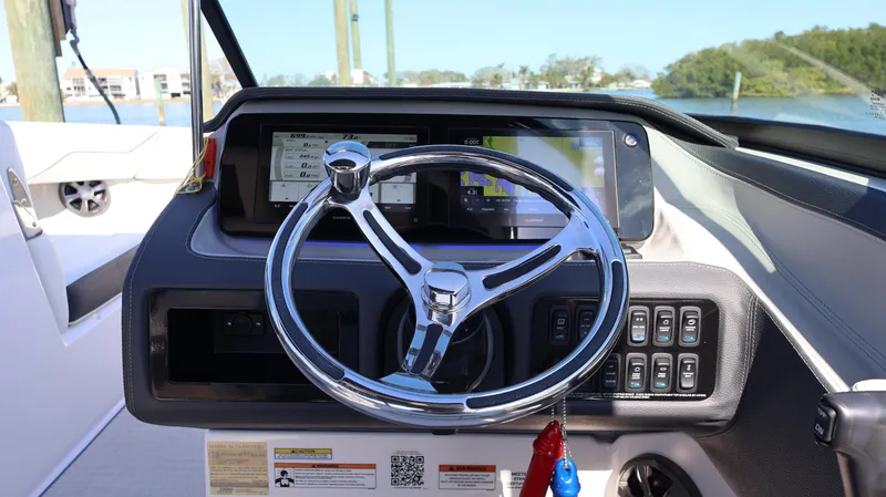 Slide: The Image of 2022 Regal LX4 boat dashboard with steering wheel and control panel. - 42