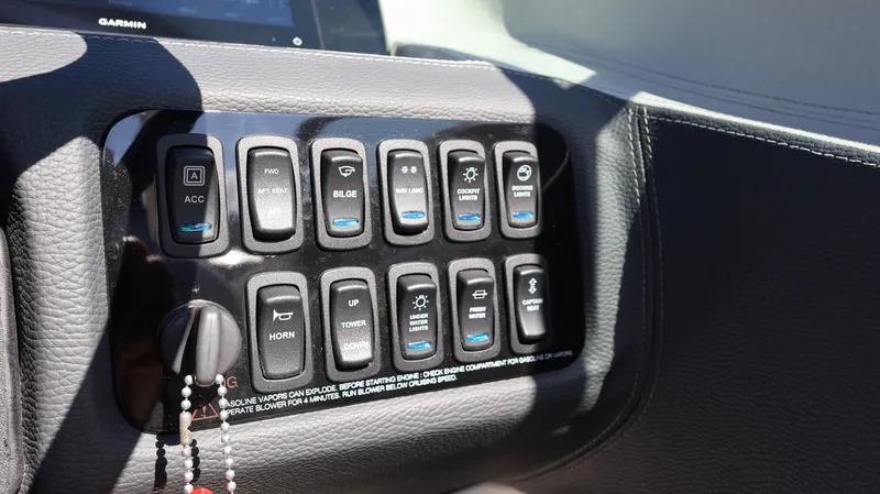 Slide: The Image of Control panel of a 2022 Regal LX4 boat with various switches and buttons. - 43
