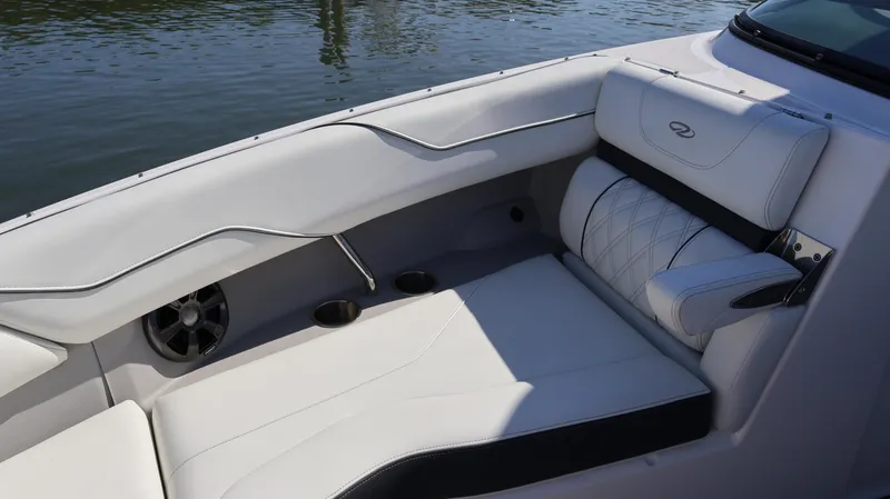 Slide: The Image of 2022 Regal LX4 boat interior with white seating and cup holders. - 48