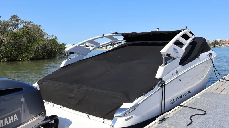 Slide: The Image of 2022 Regal LX4 boat docked with black cover, Yamaha engine visible. - 5