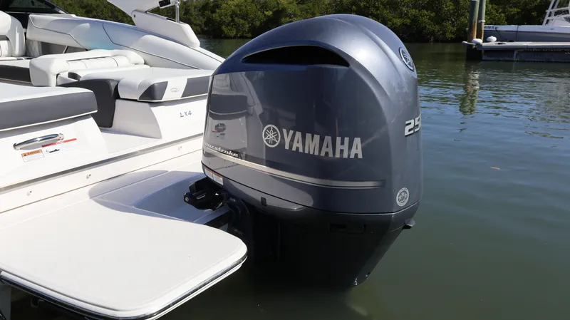 Slide: The Image of 2022 Regal LX4 boat with Yamaha 250 outboard motor on calm water. - 7