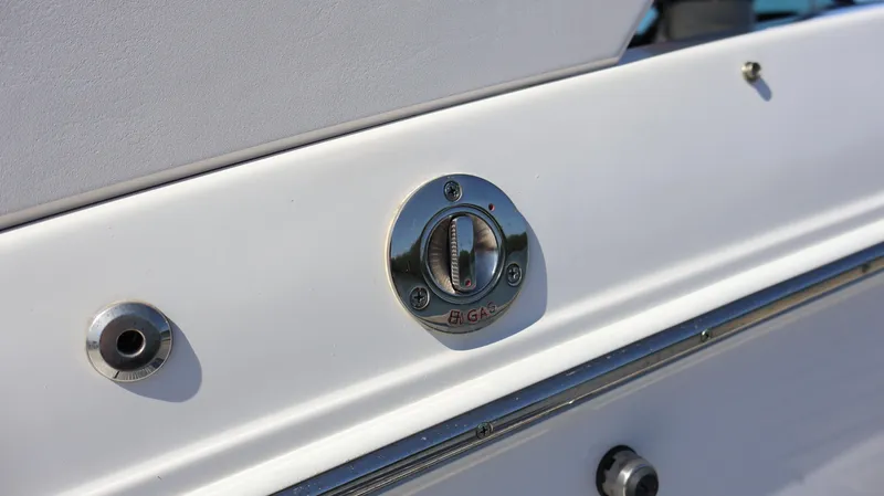 Slide: The Image of Close-up of a 2022 Regal LX4 boat's fuel cap and fittings. - 9