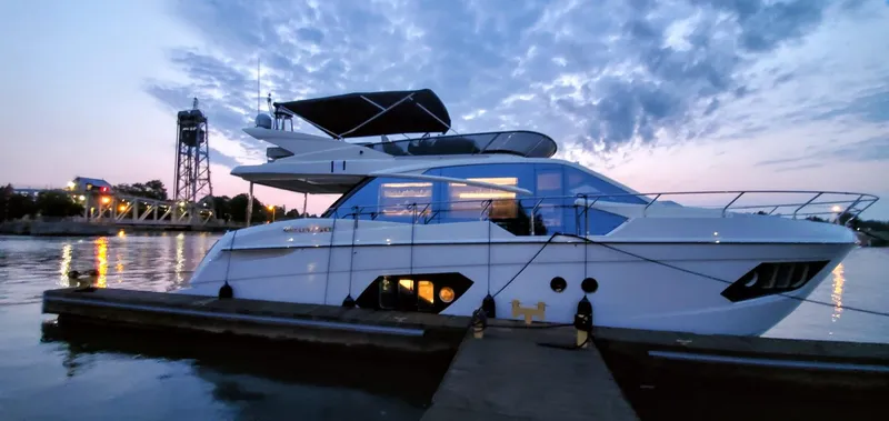 The Image of 2019 Absolute 50 Fly yacht docked at sunset with scenic background. - 0