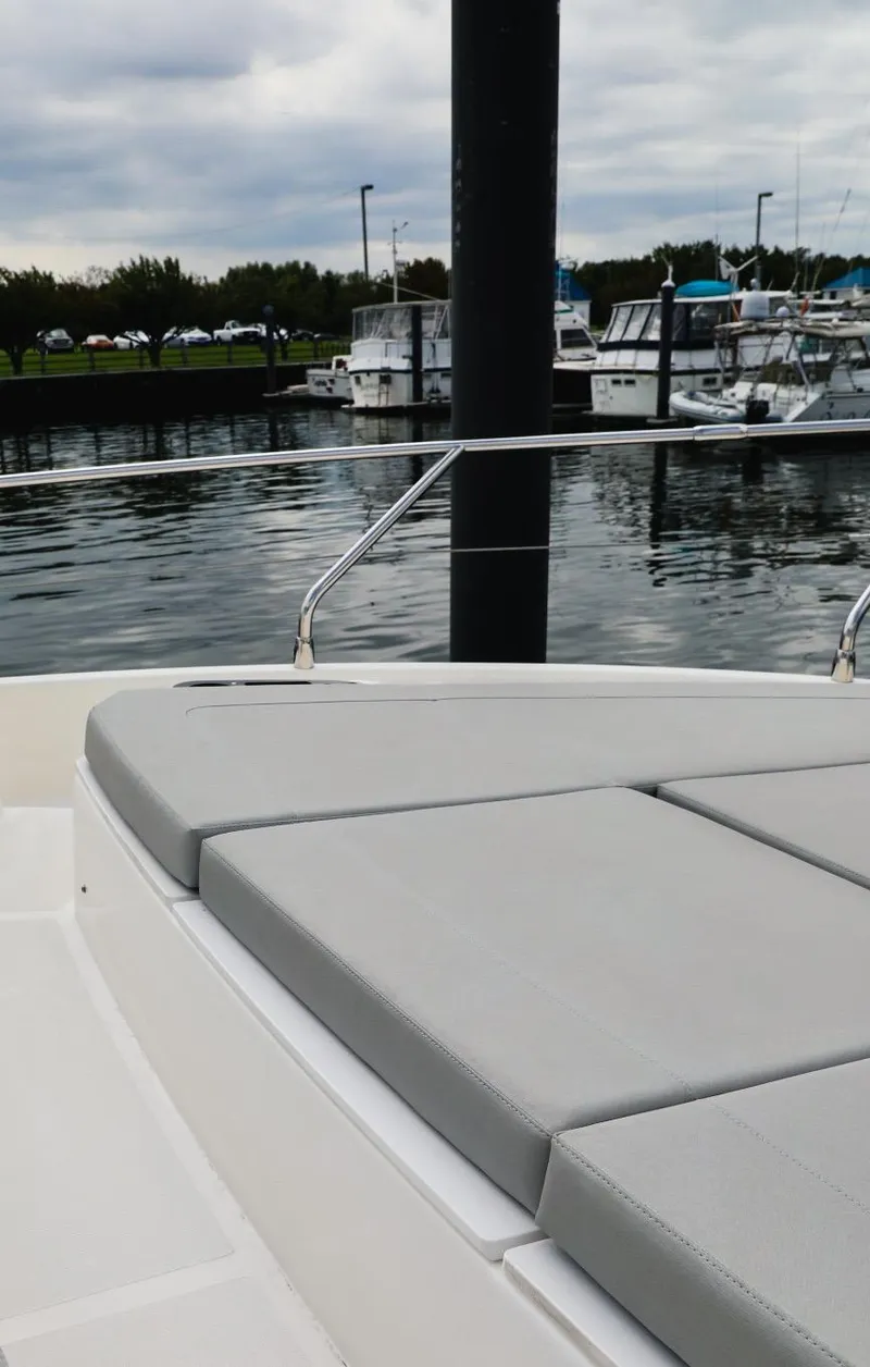 Slide: The Image of 2019 Absolute 50 Fly yacht with cushioned deck, docked in a marina. - 10