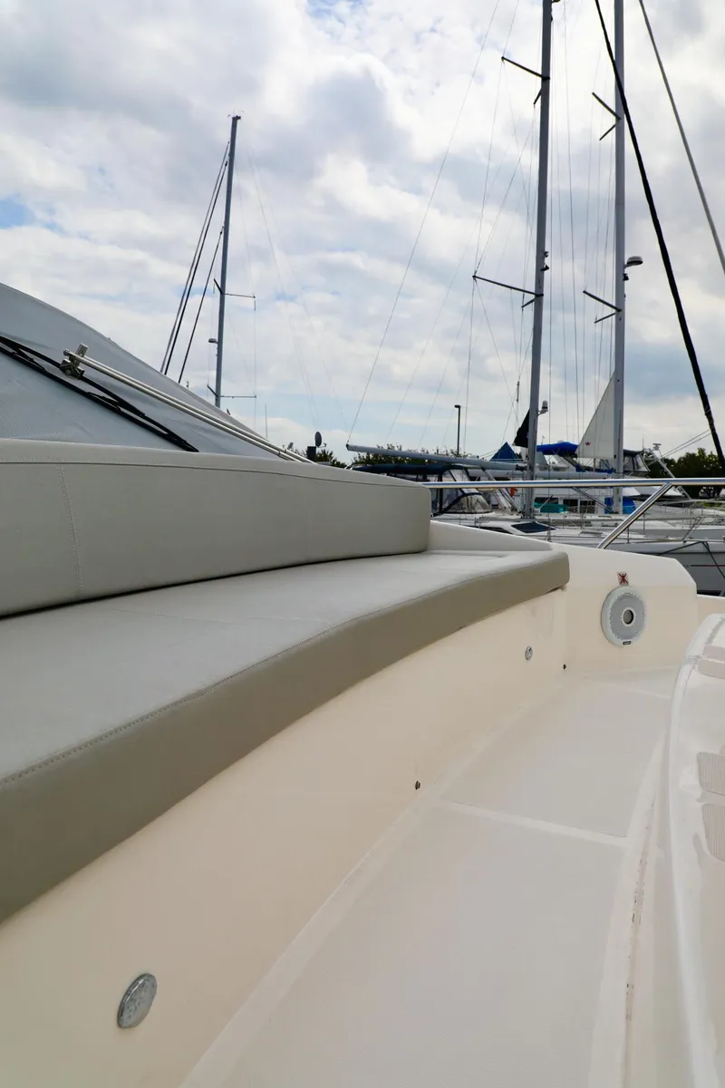 Slide: The Image of 2019 Absolute 50 Fly yacht deck with sleek design and marina backdrop. - 11