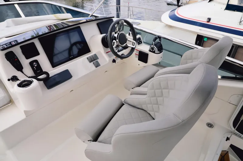Slide: The Image of Luxurious helm of 2019 Absolute 50 Fly yacht with modern controls and plush seating. - 20