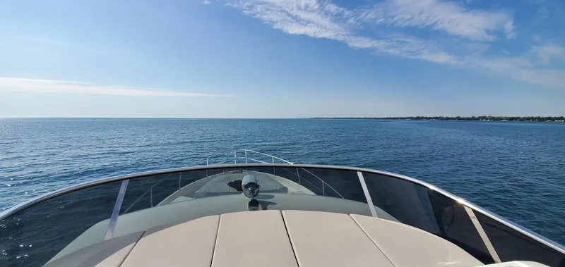 Slide: The Image of Bow view of 2019 Absolute 50 Fly yacht cruising on open sea under clear blue sky. - 26