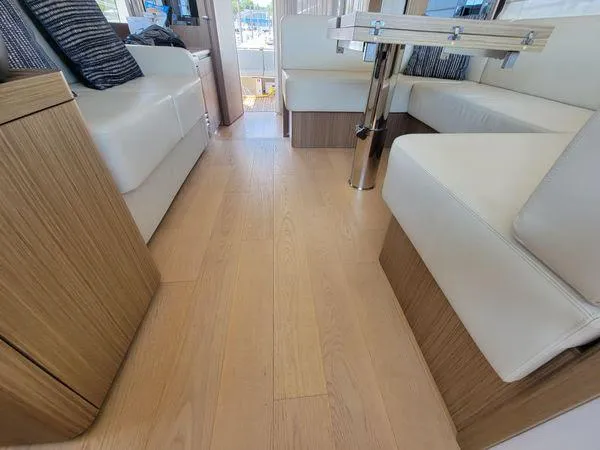 Slide: The Image of Luxurious interior of 2019 Absolute 50 Fly yacht with wooden flooring and white seating. - 35