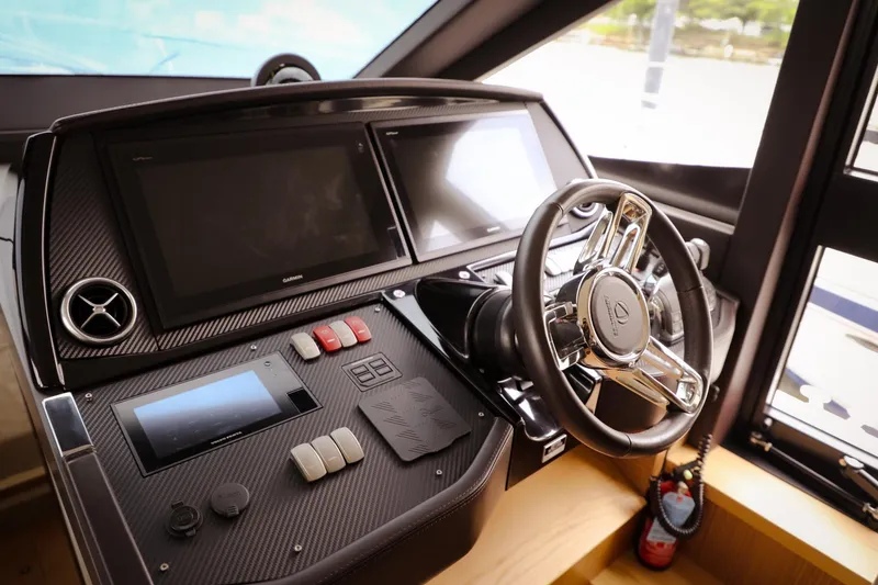 Slide: The Image of Control panel of a 2019 Absolute 50 Fly yacht with modern steering and displays. - 40