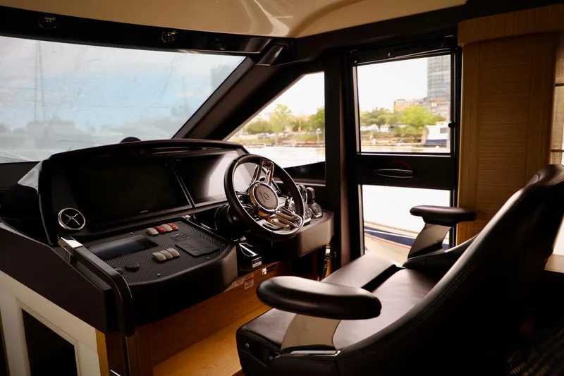 Slide: The Image of Interior cockpit of 2019 Absolute 50 Fly yacht, featuring modern steering and controls. - 41