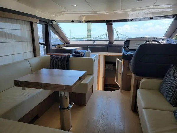 Slide: The Image of Luxurious interior of a 2019 Absolute 50 Fly yacht with modern seating and navigation area. - 44