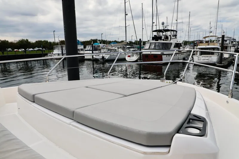 Slide: The Image of 2019 Absolute 50 Fly yacht with cushioned deck at marina. - 9