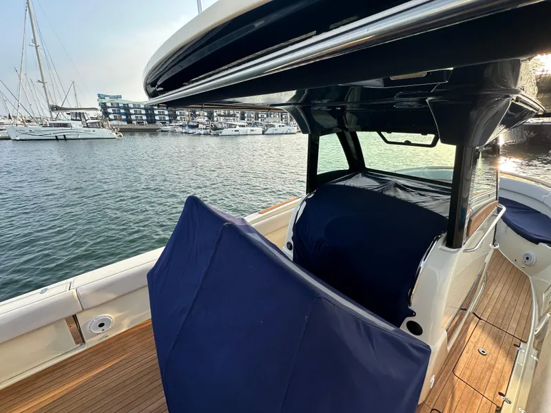 Slide: The Image of A 2021 Chris-Craft Catalina 34 on the water. It features sleek design with blue covers. - 37