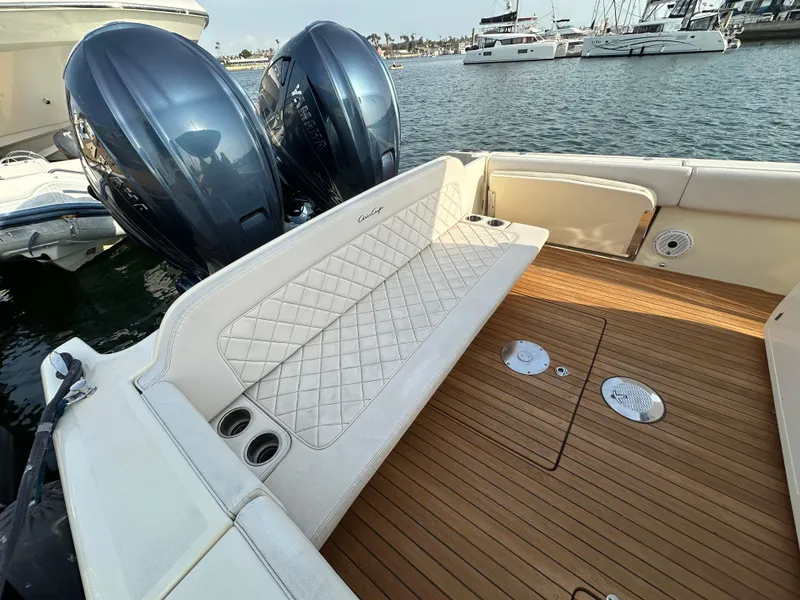 Slide: The Image of The image shows the stern of a 2021 Chris-Craft Catalina 34 with twin outboard engines and a sleek teak deck. - 5