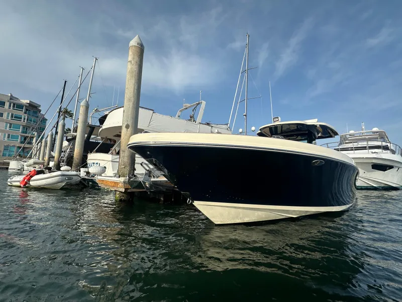 Slide: The Image of A 2021 Chris-Craft Catalina 34 is docked in the water, surrounded by other boats. - 1