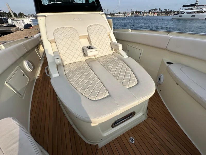 Slide: The Image of The image shows the deck of a 2021 Chris-Craft Catalina 34 with elegant, cushioned seating. - 22
