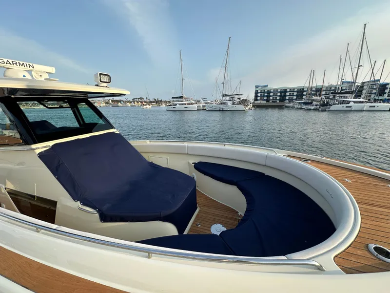 Slide: The Image of A 2021 Chris-Craft Catalina 34 on the water. It features sleek design with blue upholstery. - 38