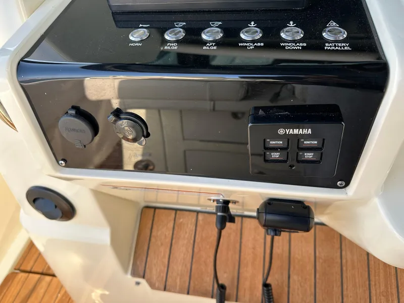 Slide: The Image of Close-up of a helm console with Yamaha controls and wood flooring. - 16