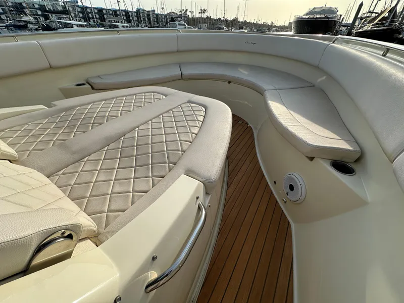Slide: The Image of The image shows the bow area of a 2021 Chris-Craft Catalina 34 with cushioned seating and wooden flooring. - 24