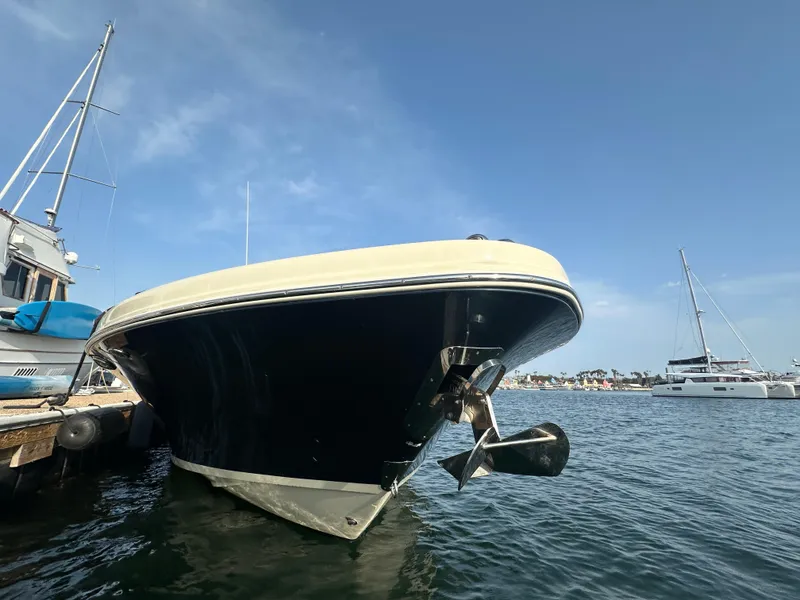 Slide: The Image of A 2021 Chris-Craft Catalina 34 boat docked. It features a sleek, black hull. - 4