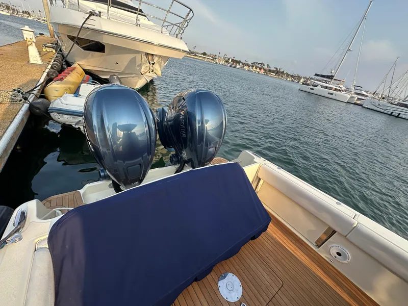 Slide: The Image of A 2021 Chris-Craft Catalina 34 docked. Two outboard engines are visible. - 36