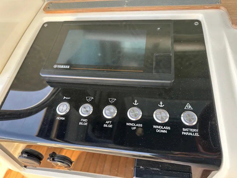 Slide: The Image of The image shows the helm of a Chris-Craft Catalina 34 boat with various control buttons. - 17