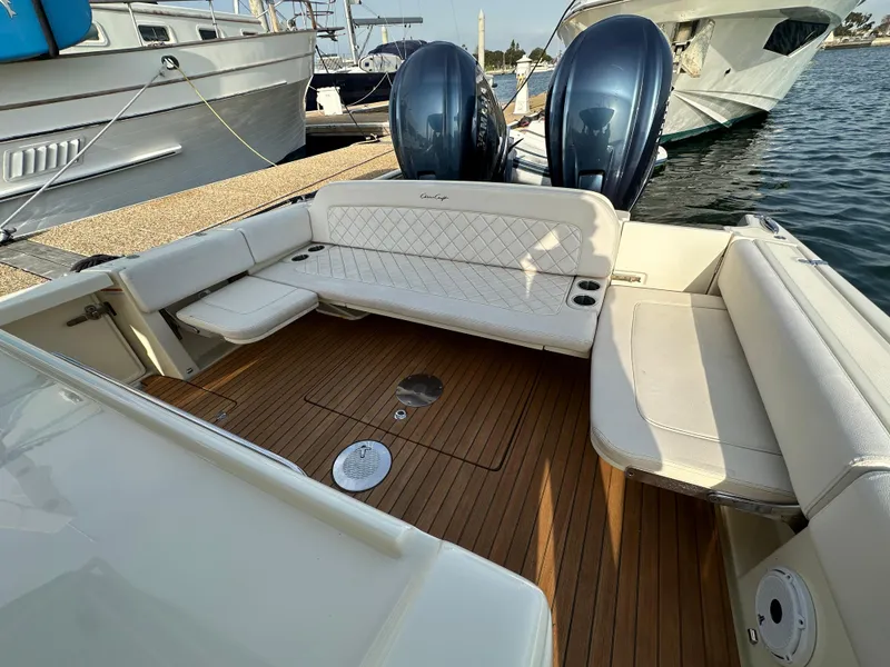 Slide: The Image of The image shows the cockpit of a 2021 Chris-Craft Catalina 34 with elegant seating and wooden flooring. - 7