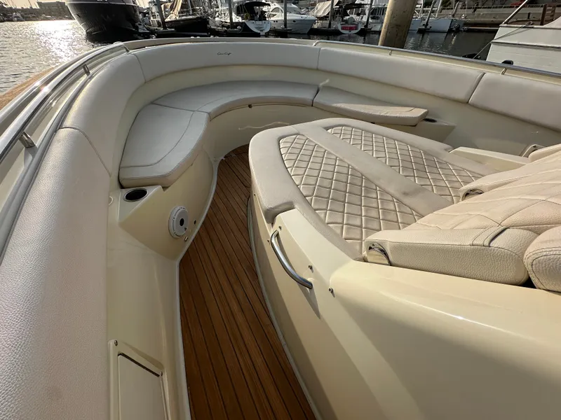 Slide: The Image of The image shows the bow of a 2021 Chris-Craft Catalina 34 with elegant upholstery and wooden flooring. - 19