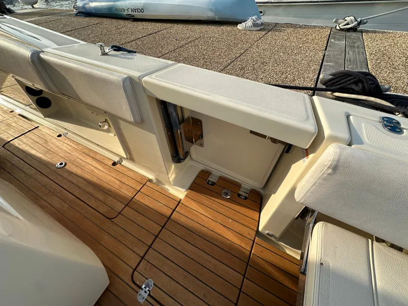 Slide: The Image of The image shows the deck of a 2021 Chris-Craft Catalina 34 with wooden flooring and cushions. - 31