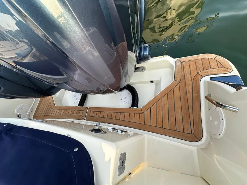 Slide: The Image of The image shows the stern of a Chris-Craft Catalina 34 boat with a teak deck. - 32