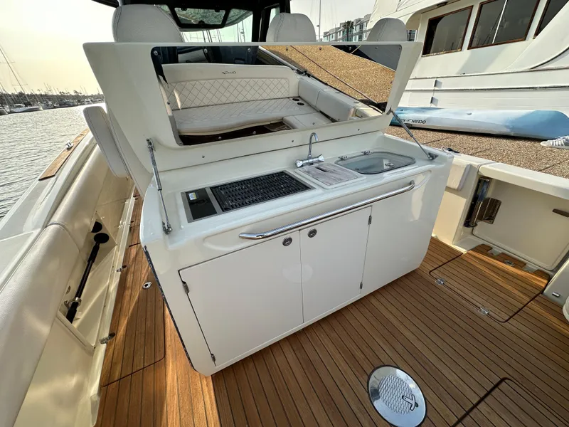 Slide: The Image of The 2021 Chris-Craft Catalina 34 features a sleek outdoor kitchen with a sink and grill. - 9