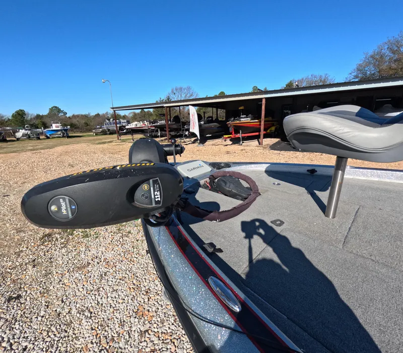 Slide: The Image of 2013 Legend Boats A211 with trolling motor and seat, parked outdoors. - 3