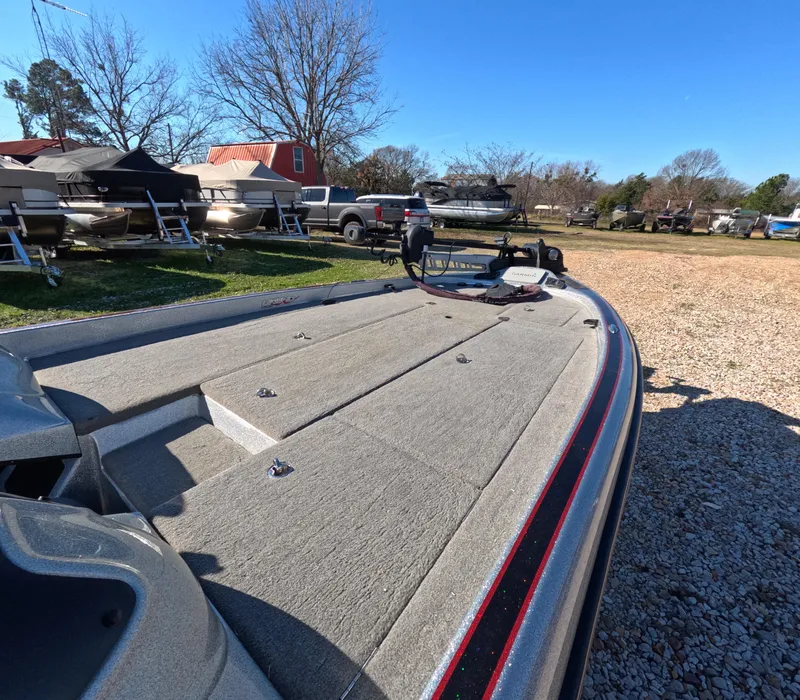 Slide: The Image of 2013 Legend Boats A211 on gravel lot, surrounded by other boats and vehicles. - 4
