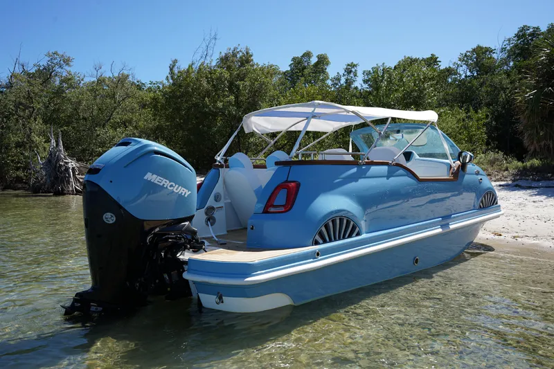 Slide: The Image of A 2025 Car Off-shore Fiat 500 Classic boat hybrid on a sunny beach. - 16