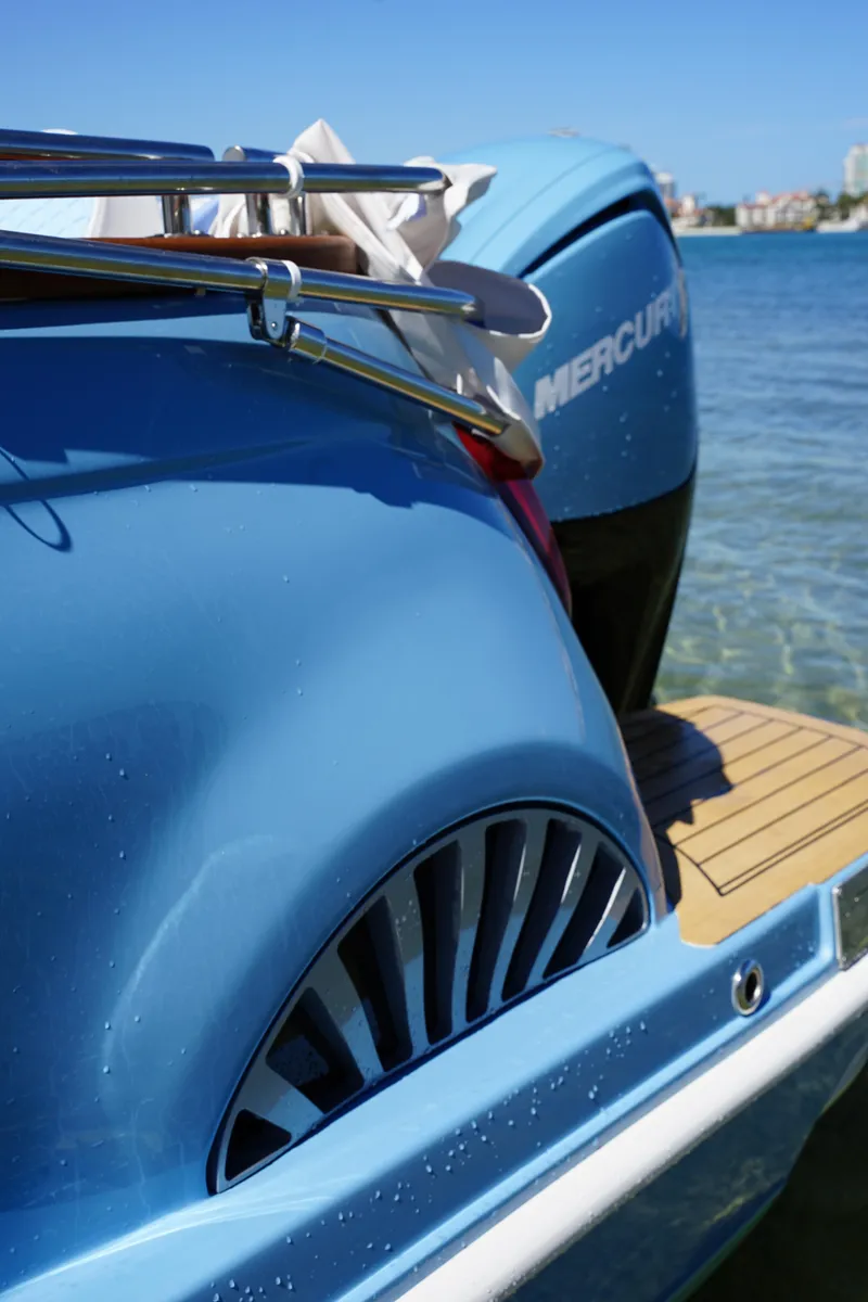 Slide: The Image of Blue Car Off-shore Fiat 500 Classic boat, 2025 model, with Mercury engine on water. - 19