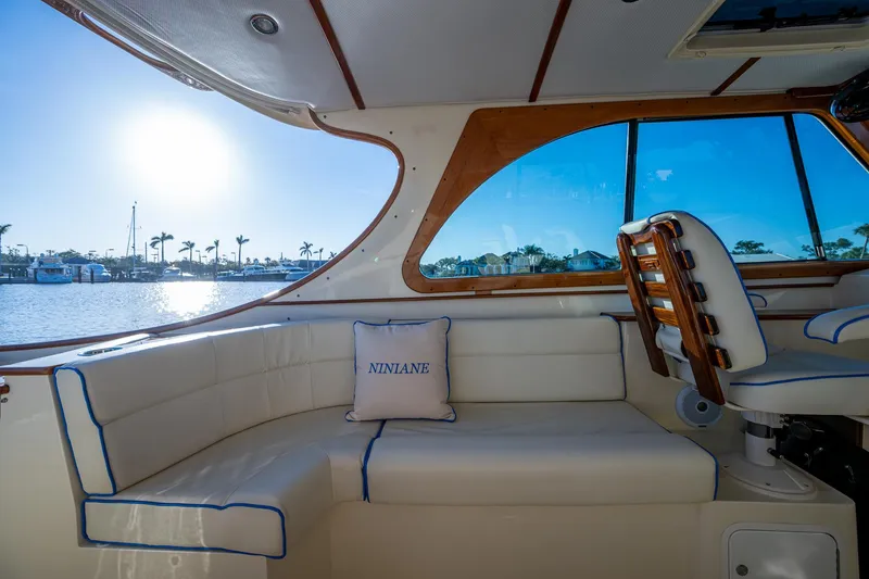 Slide: The Image of Interior of 2016 Hinckley Talaria 34 yacht with sunlit seating area and water view. - 12