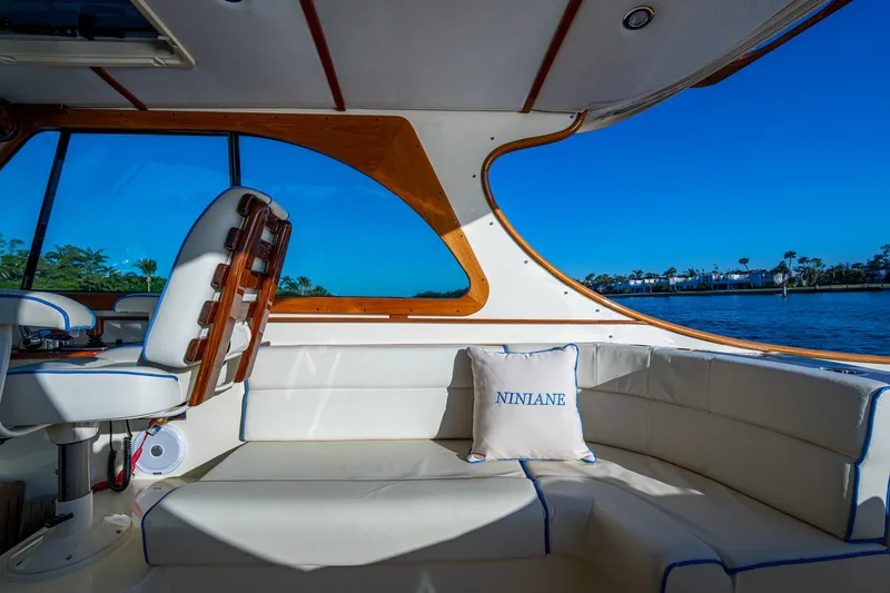 Slide: The Image of Interior of 2016 Hinckley Talaria 34 yacht with white seating and scenic water view. - 13