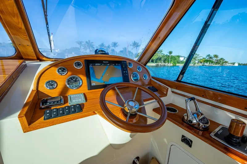 Slide: The Image of Helm of 2016 Hinckley Talaria 34 yacht with wooden steering wheel and navigation instruments. - 14