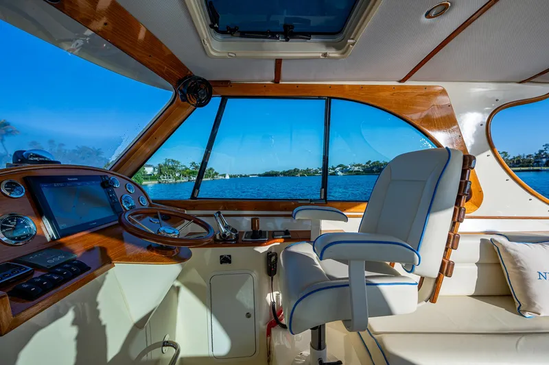 Slide: The Image of Interior of 2016 Hinckley Talaria 34 yacht with helm and seating, overlooking water. - 15