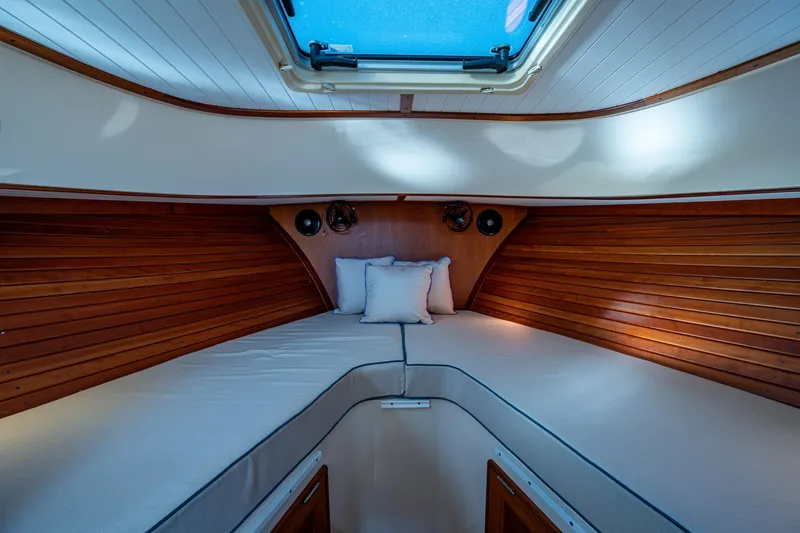 Slide: The Image of 2016 Hinckley Talaria 34 cabin interior with wooden paneling and skylight. - 21