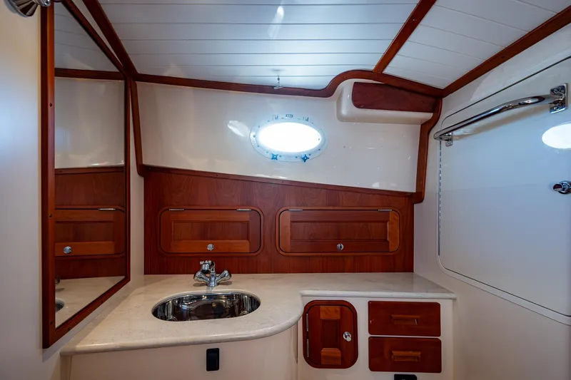 Slide: The Image of Luxurious 2016 Hinckley Talaria 34 yacht bathroom with elegant wood accents and modern fixtures. - 22