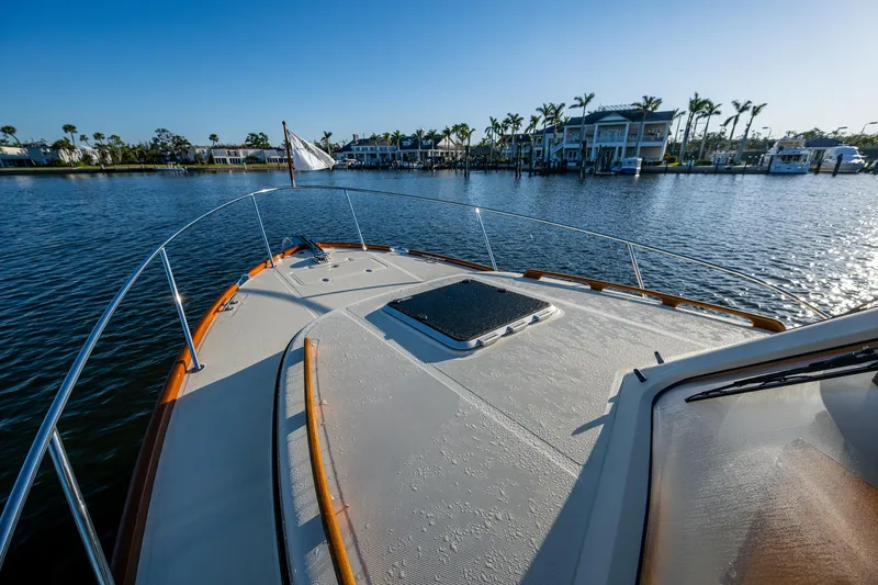 Slide: The Image of 2016 Hinckley Talaria 34 yacht on calm water with scenic waterfront view. - 29