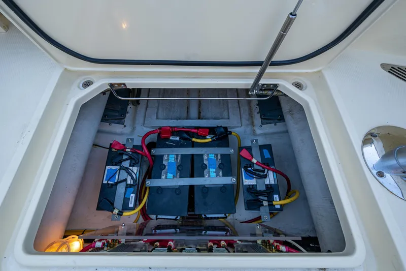 Slide: The Image of Battery compartment of a 2016 Hinckley Talaria 34 boat, showing multiple batteries and wiring. - 32