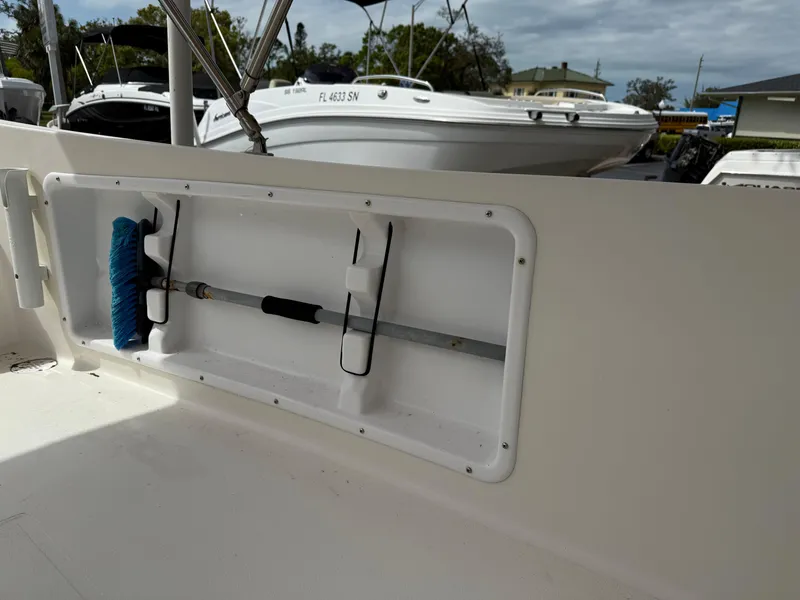 Slide: The Image of Atlas Boat Works Pompano 23, 2015 model, with onboard storage compartment and cleaning tools. - 13