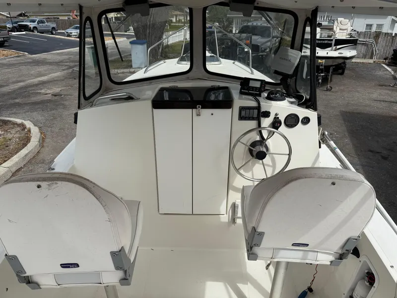 Slide: The Image of 2015 Atlas Boat Works Pompano 23 interior with dual seats and steering console. - 17